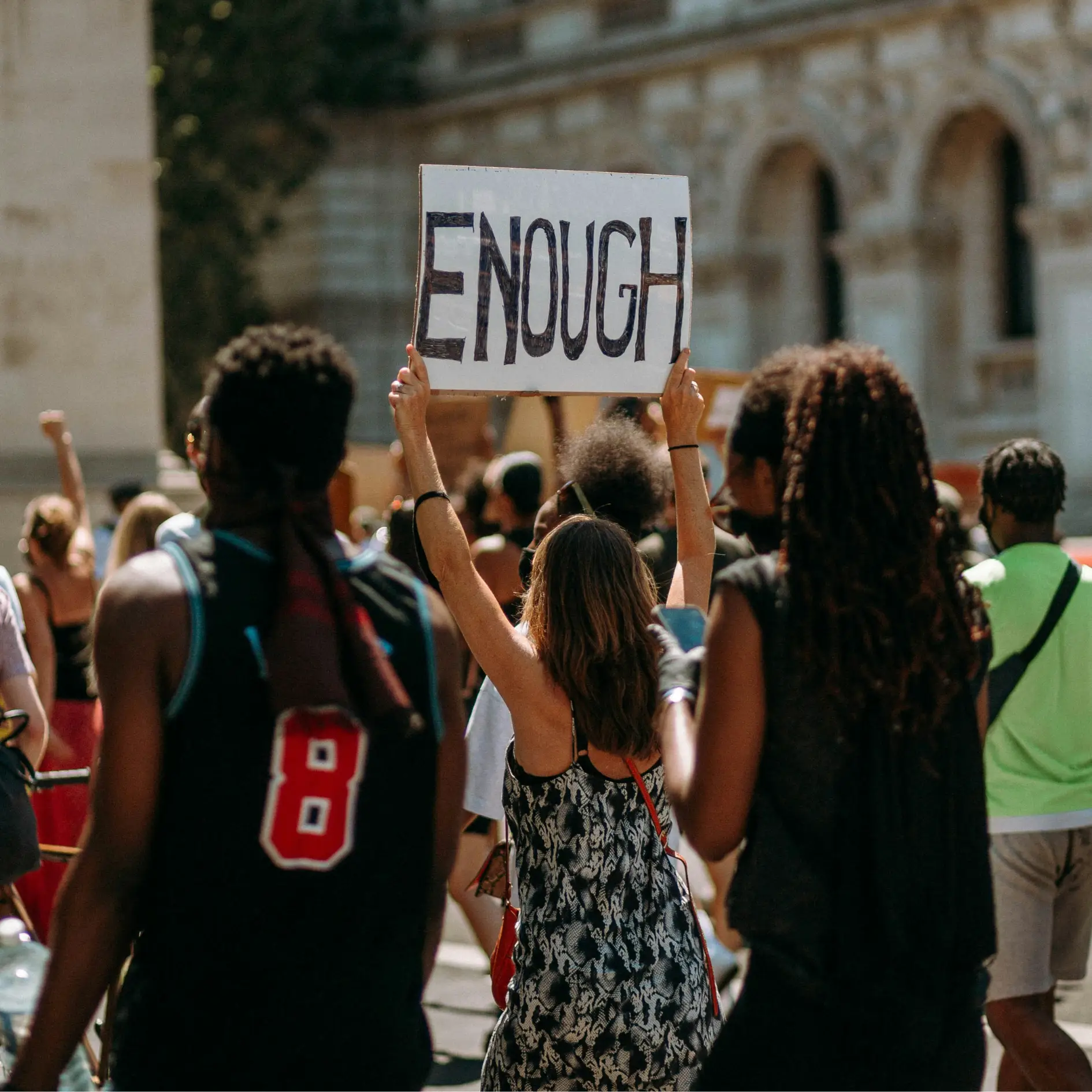 Photo of a group of young people carrying protest signs on a college campus