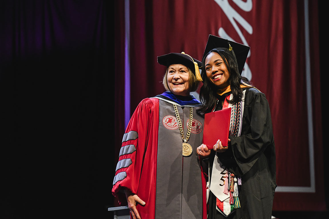 president harring poses with graduate at muhlenberg college commencement